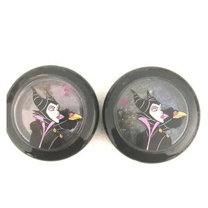 Two Disney/MAC cosmetics eyeshadows.